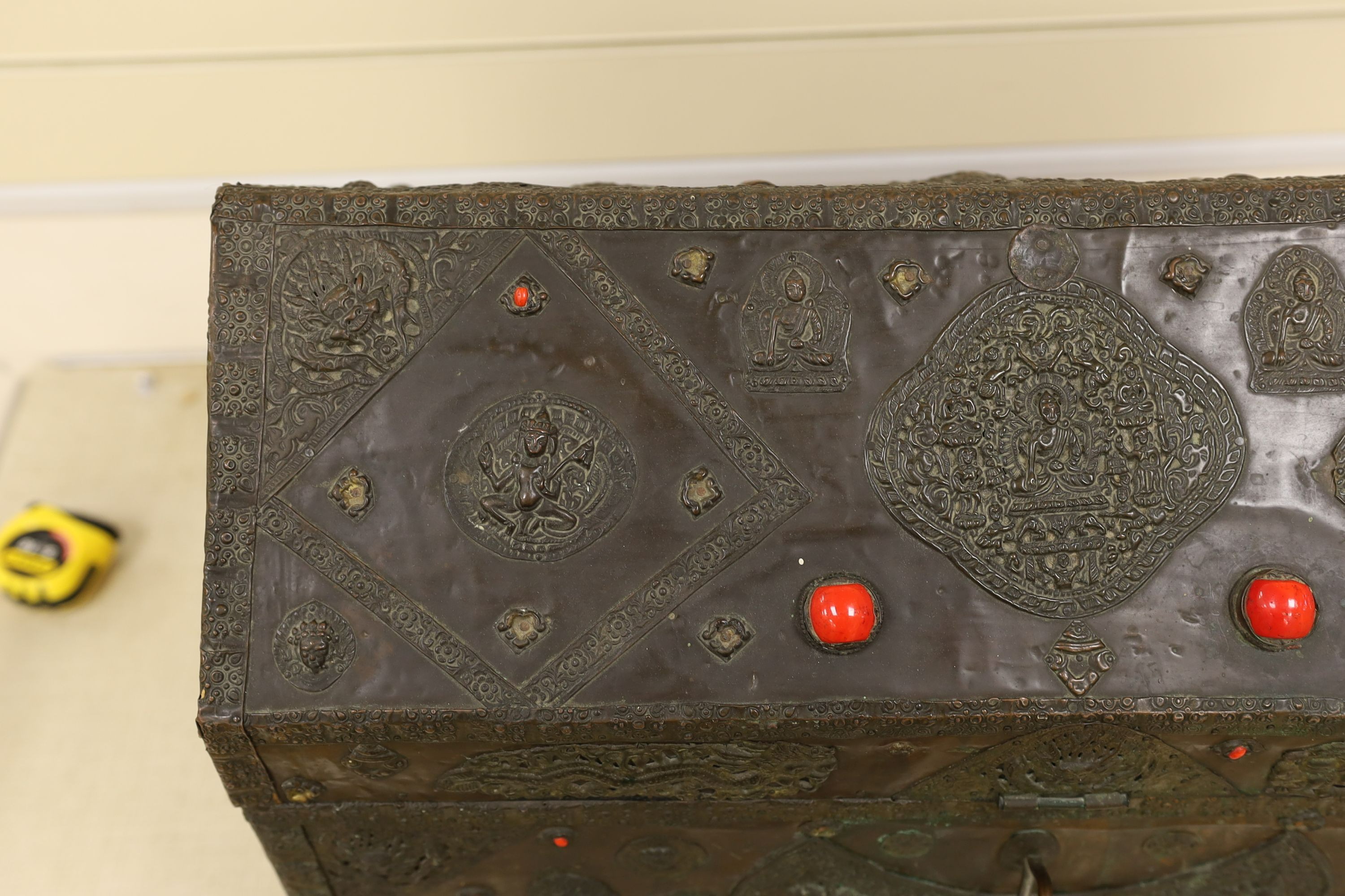 A Tibetan copper repousse-work casket, 20th century, 65cm wide, 49.5cm